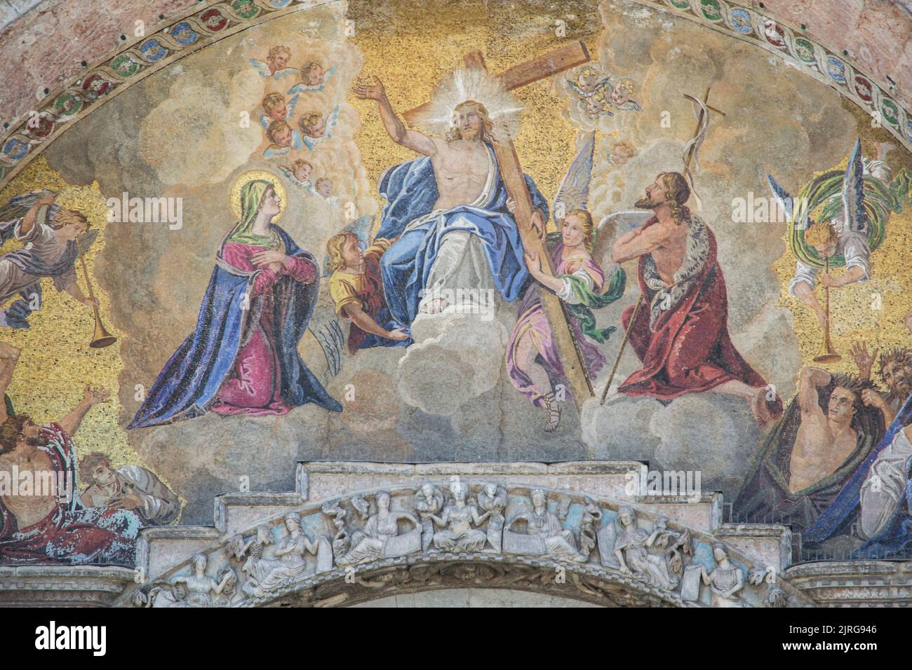 St Mark`s Basilica close-up, Venice, Italy. It is top landmark in Venice. Beautiful luxury mosaic portal, image of Christ and cross. Stock Photo
